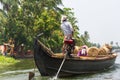 Allepey, Kerala, India Ã¢â¬â March 31, 2015: Indian man transport dwell with rice for boats. backwaters canoe in state Royalty Free Stock Photo